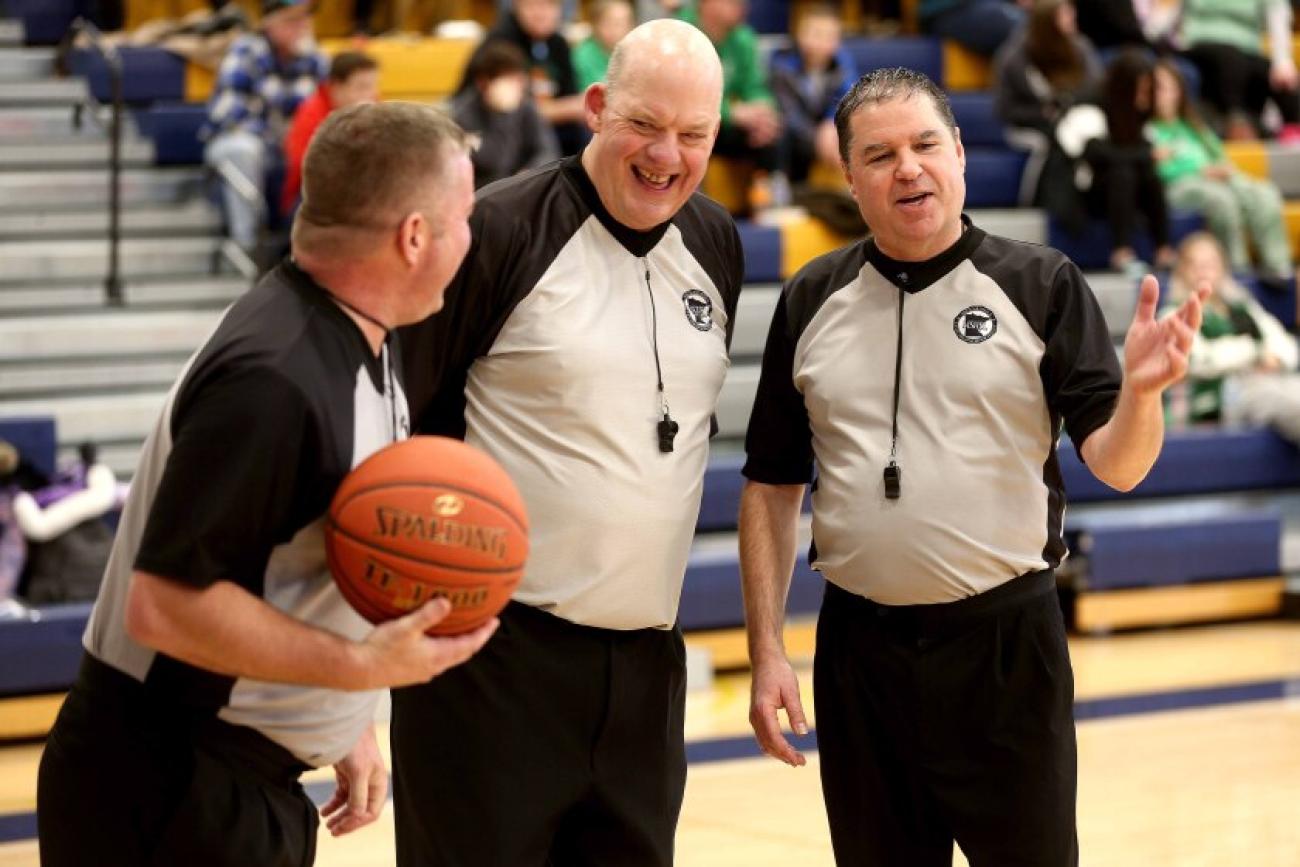 Ely's Paul McDonald, center, retired from high school and basketball officiating in 2023 after 35 years of service.