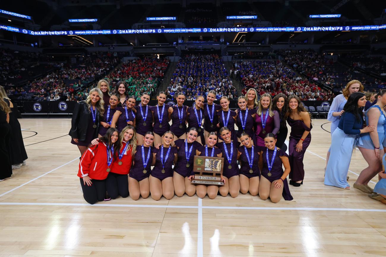 The Benilde-St. Margaret's Dance Team poses with its 2025 Jazz State Championship trophy.