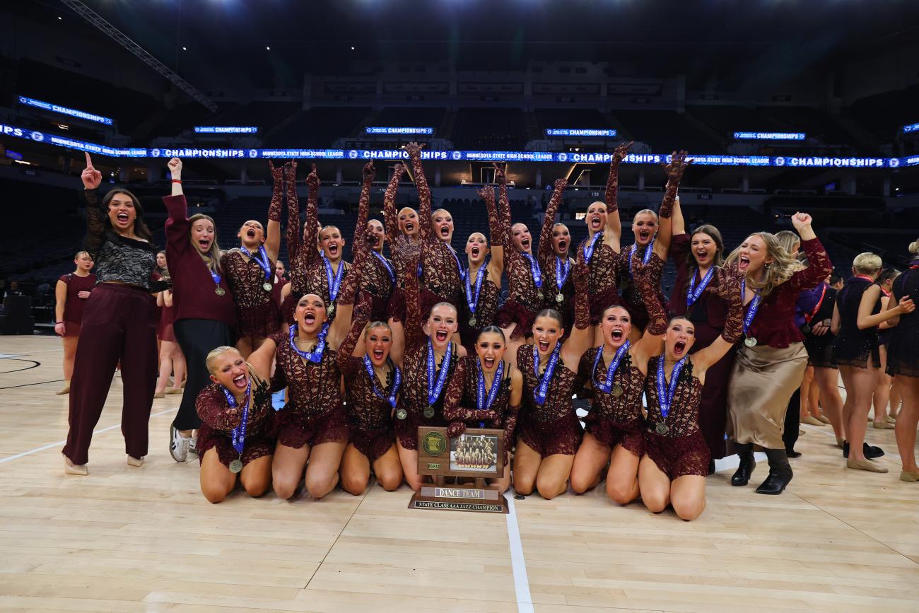 The Eastview Dance Team poses with the 2025 Dance Team Jazz State Championship trophy.