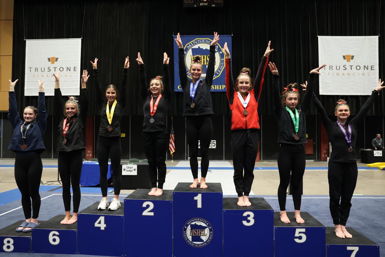 The top eight Class A all-around finishers pose on the awards podium.