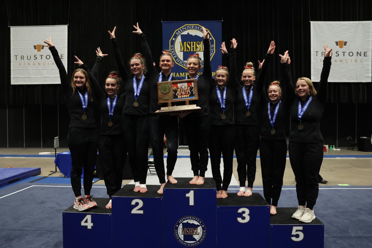 The Detroit Lakes Girls Gymnastics team poses with its 2025 state championship trophy.