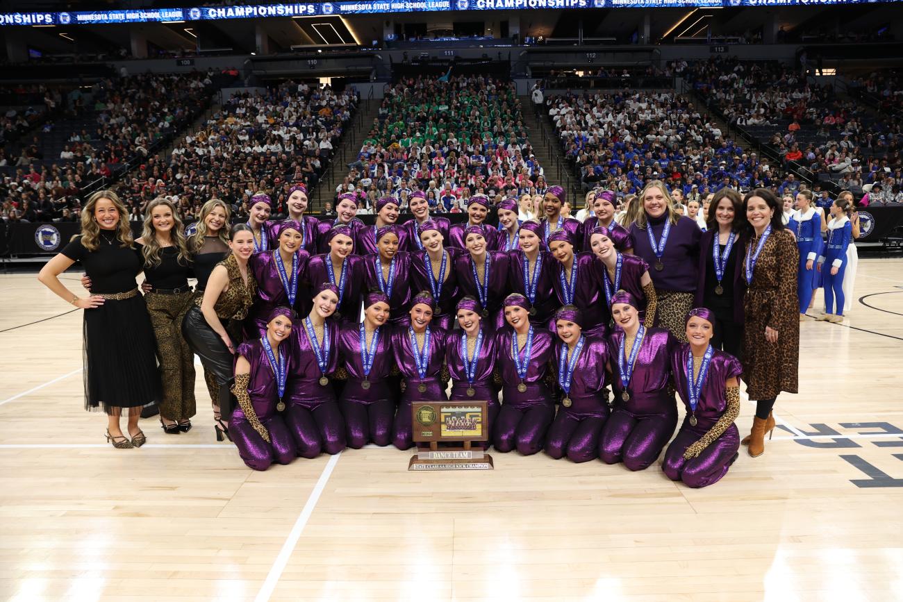 The Totino-Grace Dance Team poses with its 2025 Class AA High Kick State Championship trophy.