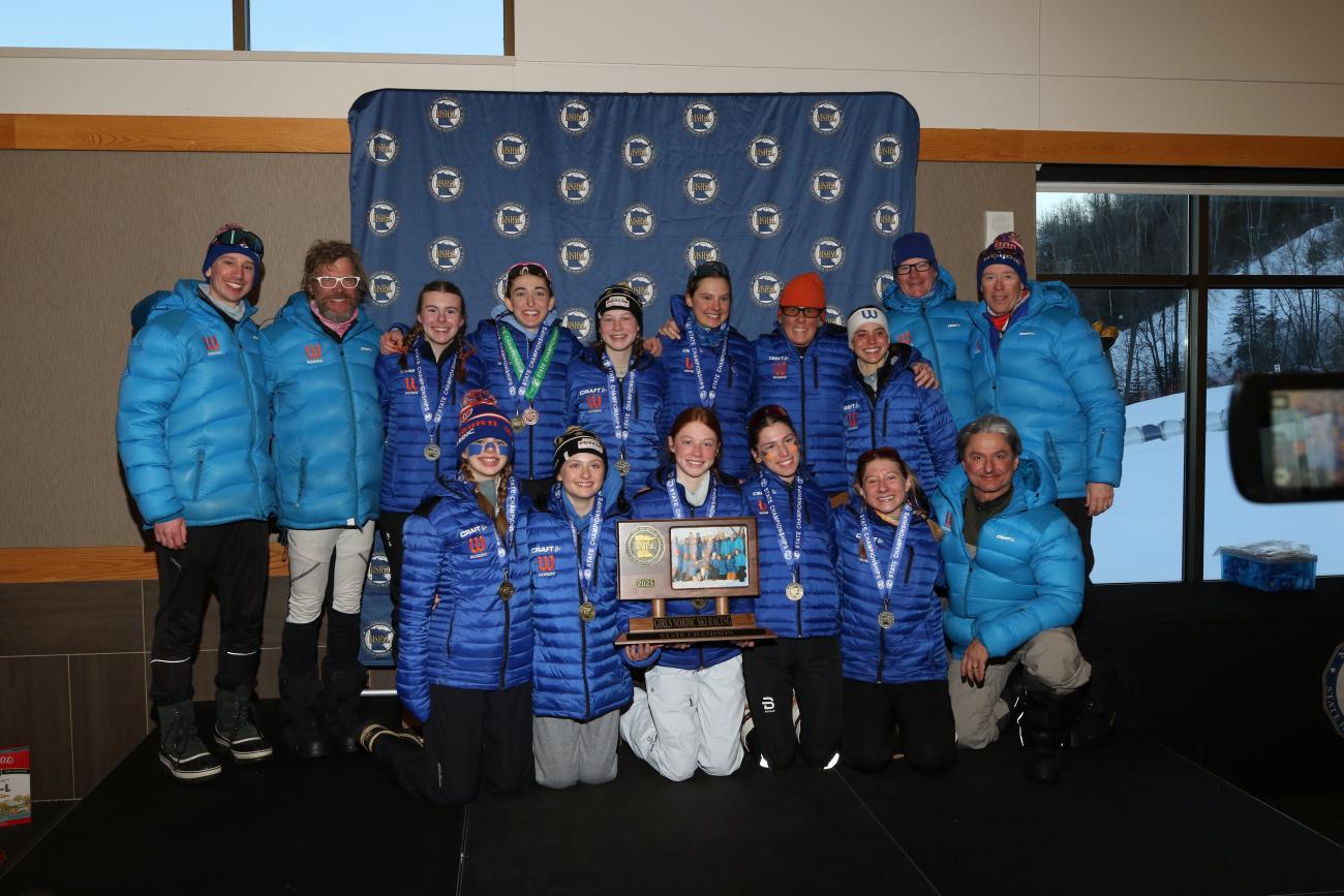 The 2025 Minneapolis Washburn Girls Nordic Ski Racing team poses with its State Championship trophy.