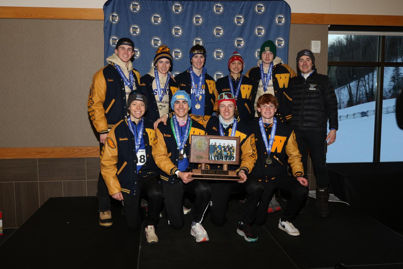 The 2025 Wayzata Boys Nordic Ski Racing team poses with its State Championship trophy.