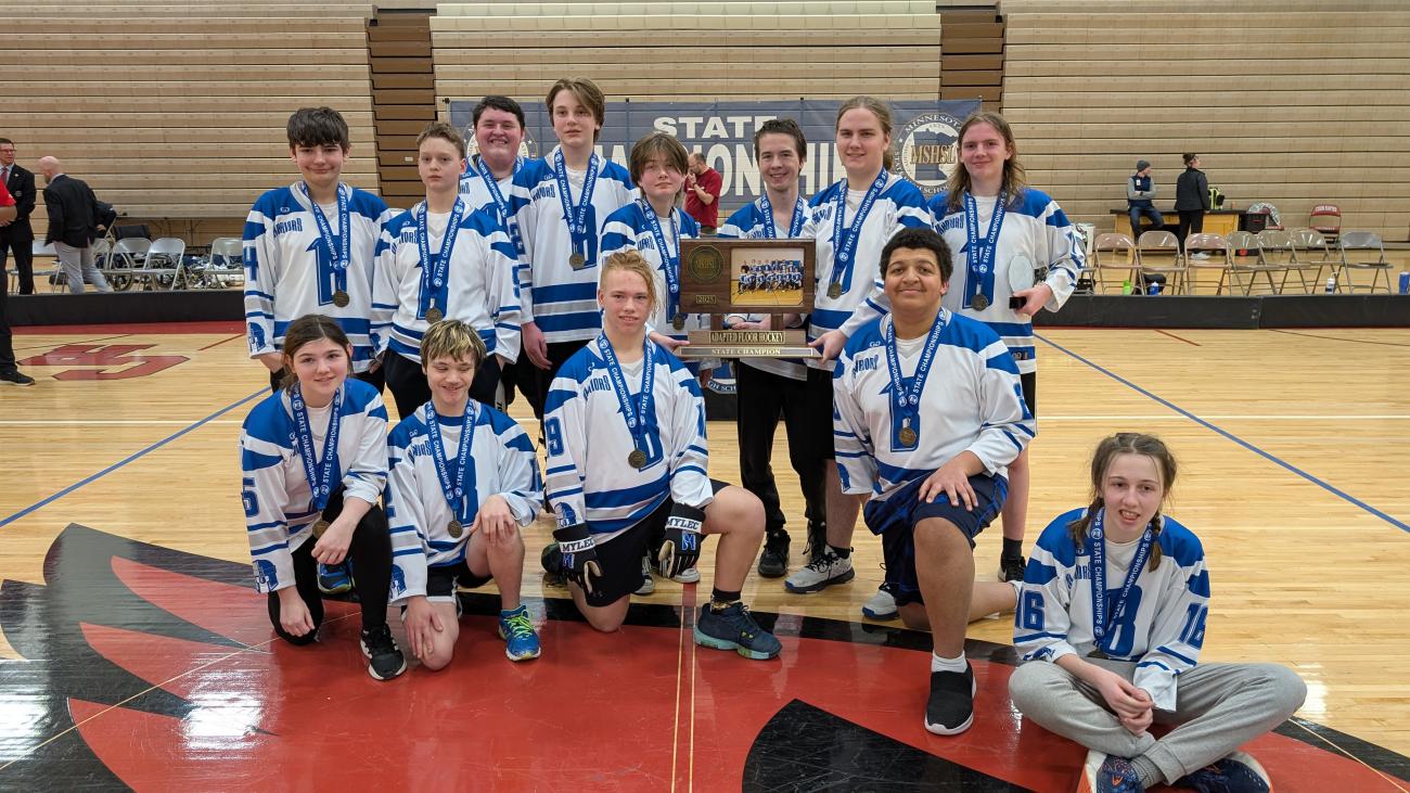 The Brainerd Adapted Floor Hockey PI Team poses with its state championship trophy.