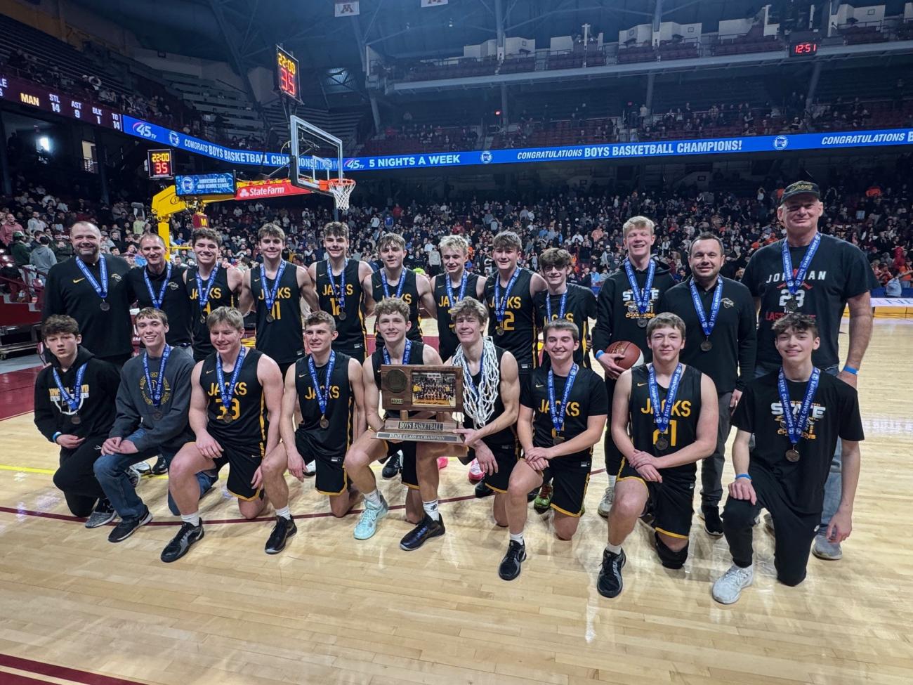 The Dawson-Boyd Boys Basketball team poses with its Class A state championship trophy.