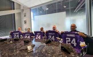 Members of the NFL/NFHS Crew of the Year -- Pat Bergquist, MJ Wagenson, Kevin Britt, Pete Cheeley and Dennis Harris -- hold up custom Minnesota Vikings jerseys with the number 24.
