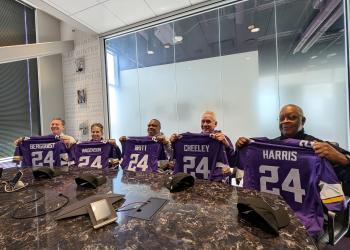 Members of the NFL/NFHS Crew of the Year -- Pat Bergquist, MJ Wagenson, Kevin Britt, Pete Cheeley and Dennis Harris -- hold up custom Minnesota Vikings jerseys with the number 24.